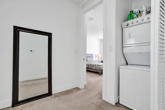 a room with a bed and a refrigerator