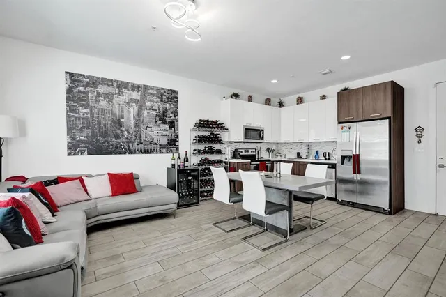 a living room with furniture and kitchen view
