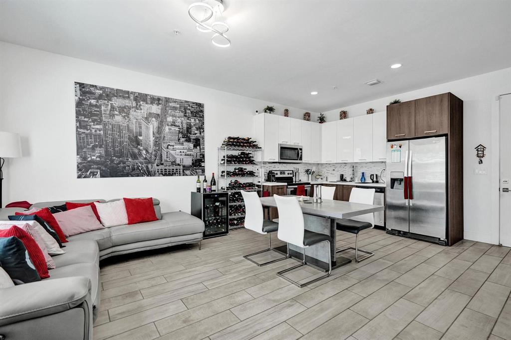 480 Northeast 35th Court, Unit 2 Oakland Park, FL 33334 - Photo 3 of 35 a living room with furniture and kitchen view
