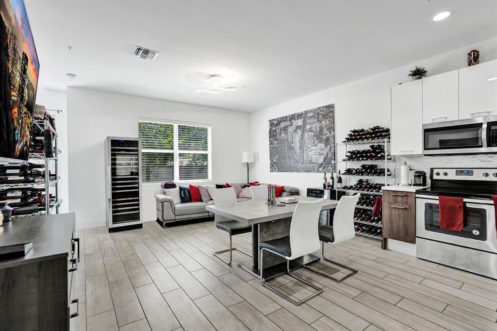 480 Northeast 35th Court, Unit 2 Oakland Park, FL 33334 - Photo 5 of 35 a room with furniture and a flat screen tv