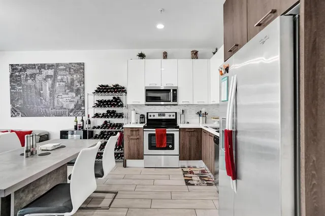 a kitchen with stainless steel appliances a stove a refrigerator and a refrigerator