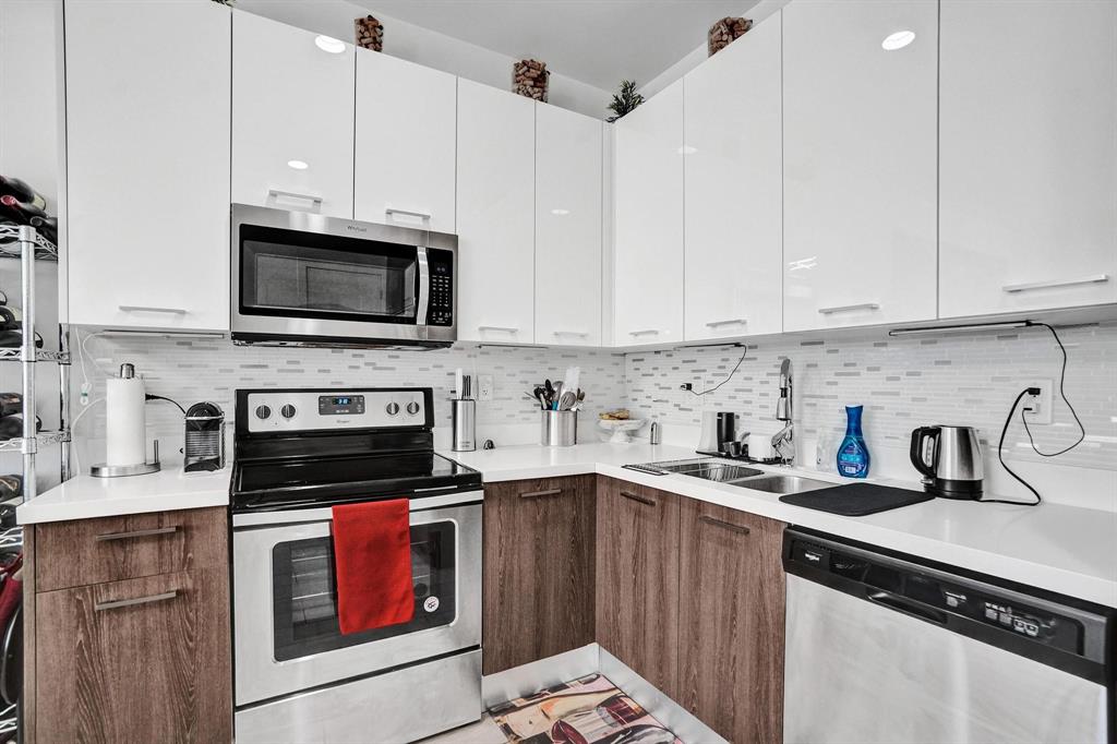 480 Northeast 35th Court, Unit 2 Oakland Park, FL 33334 - Photo 8 of 35 a kitchen with a sink and steel appliances