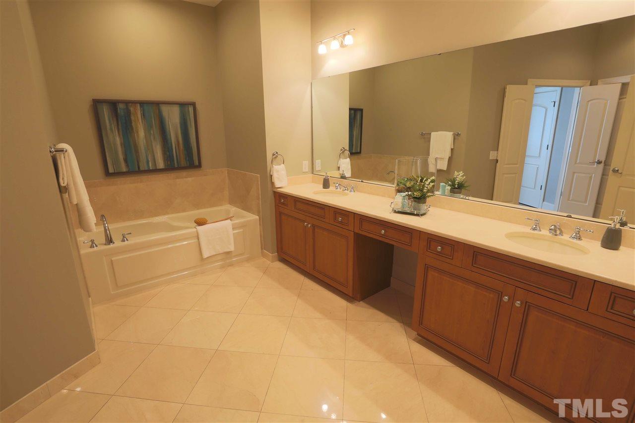 317 West Morgan Street, Unit 412 Raleigh, NC 27601 - Photo 14 of 25 a bathroom with a tub sink and mirror