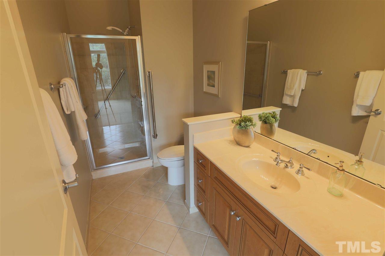 317 West Morgan Street, Unit 412 Raleigh, NC 27601 - Photo 17 of 25 a bathroom with a sink a toilet and shower