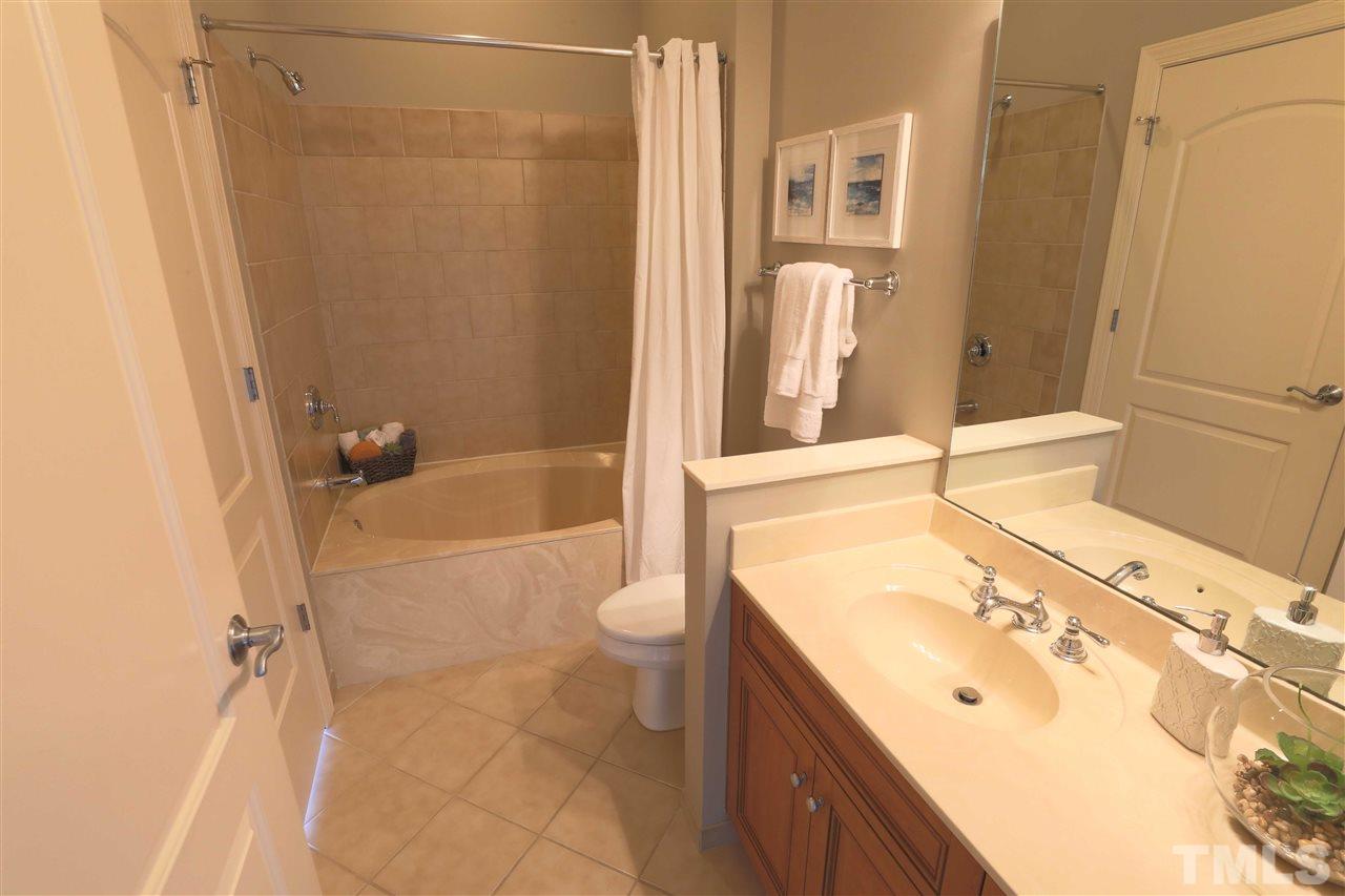317 West Morgan Street, Unit 412 Raleigh, NC 27601 - Photo 19 of 25 a bathroom with a granite countertop sink toilet and shower
