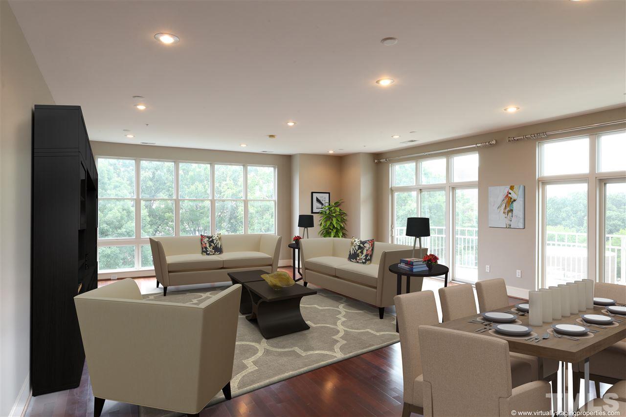 317 West Morgan Street, Unit 412 Raleigh, NC 27601 - Photo 3 of 25 a living room with furniture and a large window