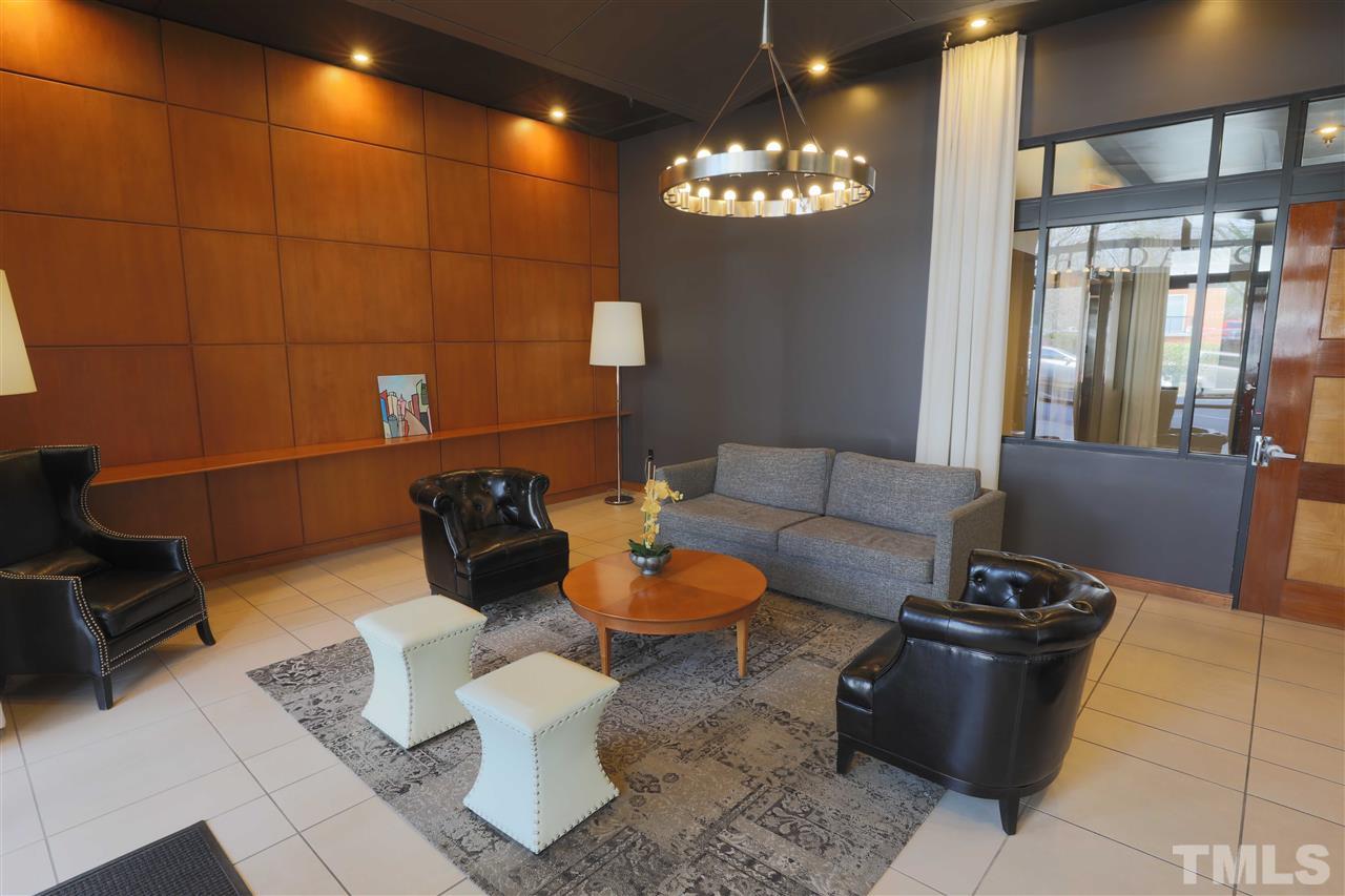 317 West Morgan Street, Unit 412 Raleigh, NC 27601 - Photo 21 of 25 a living room with furniture and a chandelier