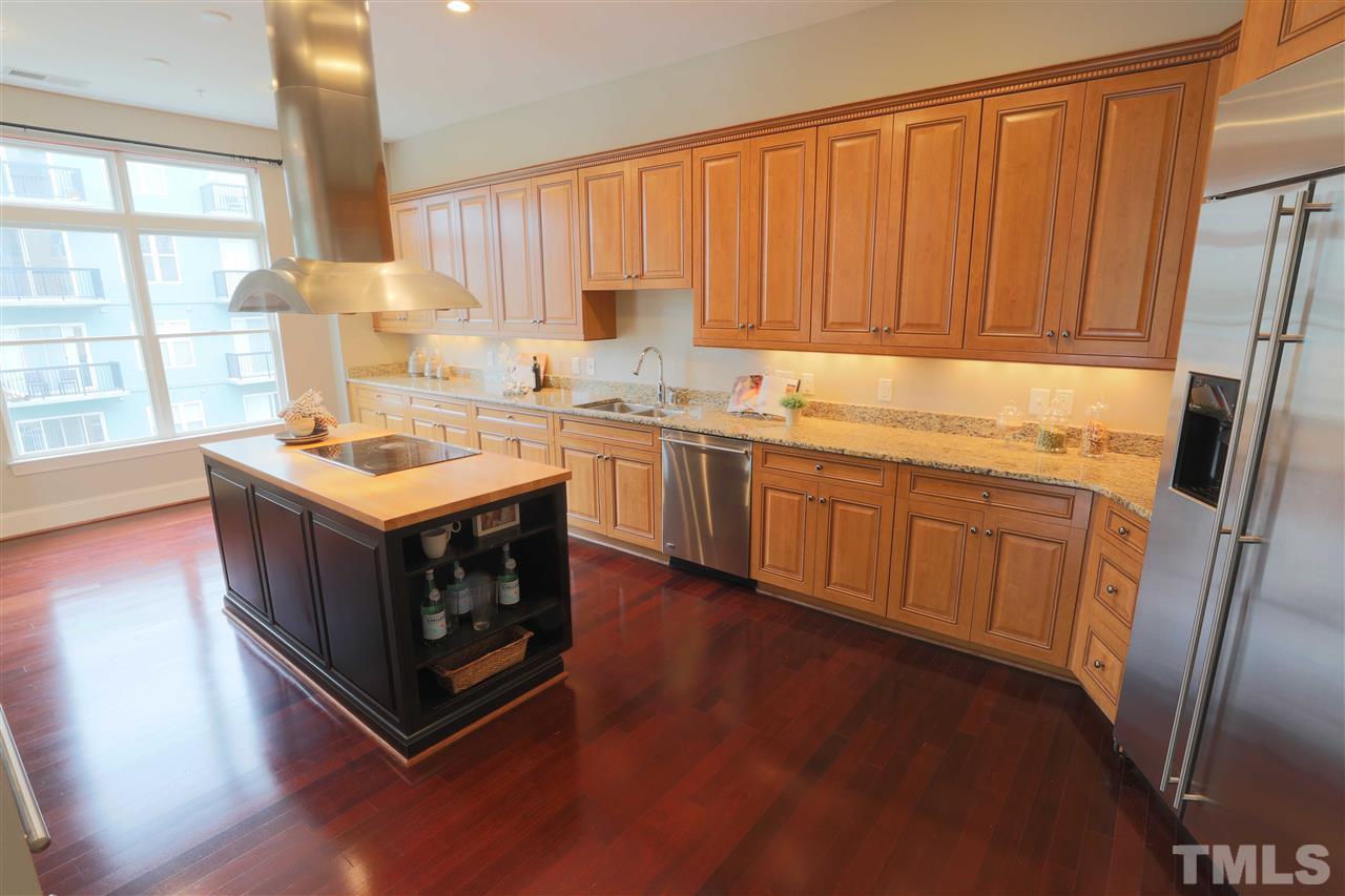 317 West Morgan Street, Unit 412 Raleigh, NC 27601 - Photo 4 of 25 a kitchen with a sink stove and cabinets