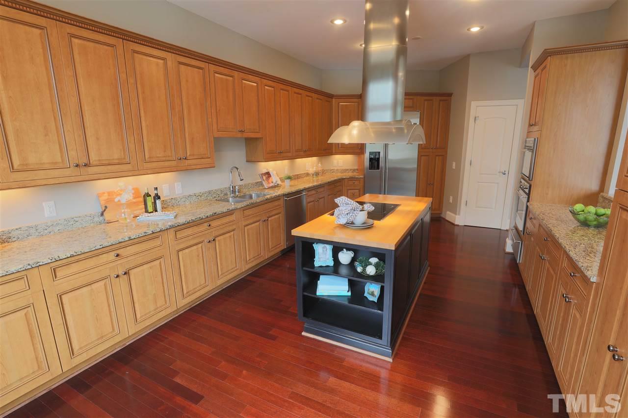 317 West Morgan Street, Unit 412 Raleigh, NC 27601 - Photo 6 of 25 a kitchen with stainless steel appliances granite countertop a stove a sink dishwasher and a refrigerator with wooden floor