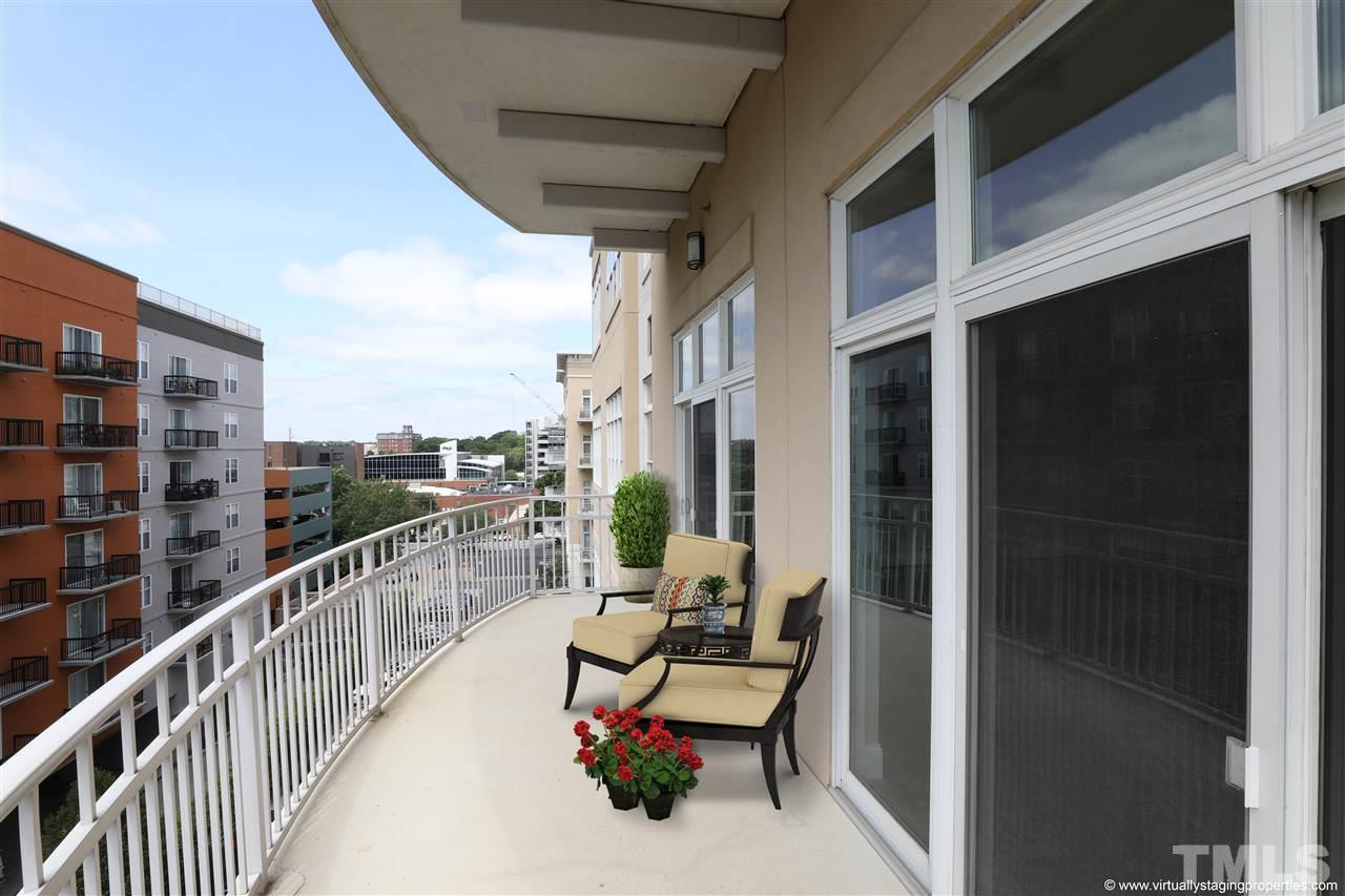 317 West Morgan Street, Unit 412 Raleigh, NC 27601 - Photo 7 of 25 a balcony with wooden floor and city view