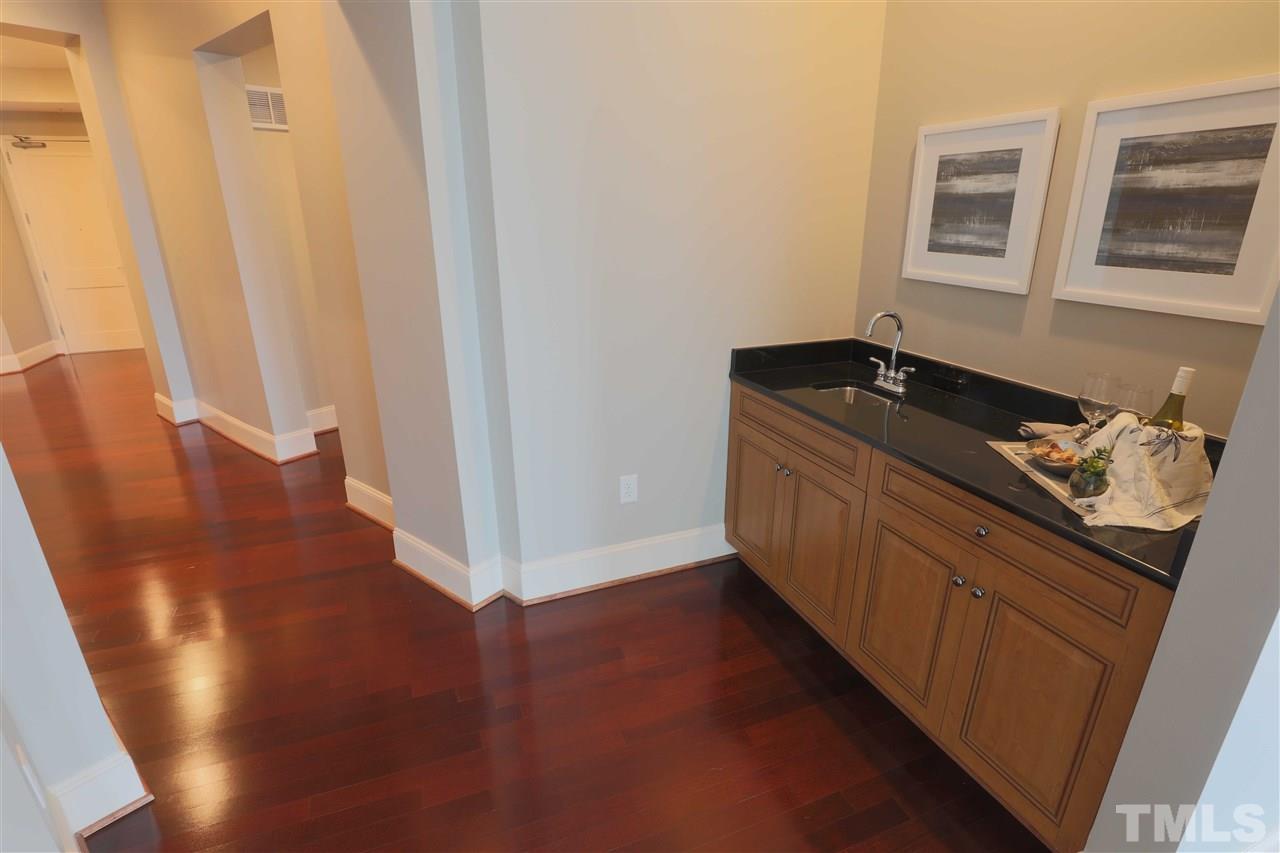 317 West Morgan Street, Unit 412 Raleigh, NC 27601 - Photo 9 of 25 a kitchen with stainless steel appliances granite countertop a refrigerator