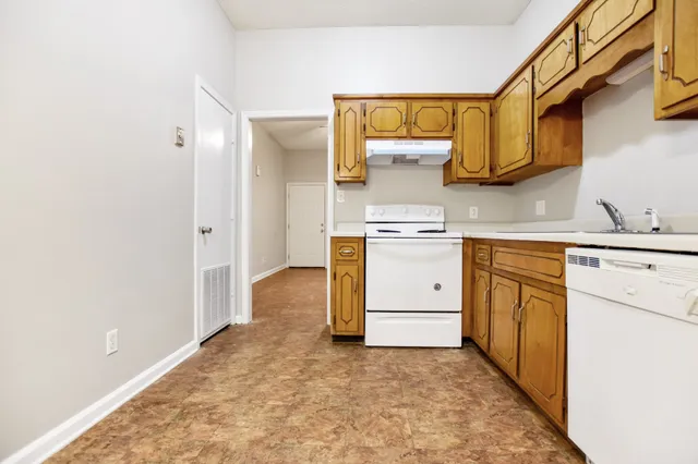 a kitchen with a stove a sink and a refrigerator