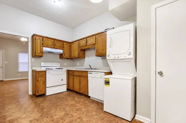 a kitchen with granite countertop cabinets stainless steel appliances and a sink