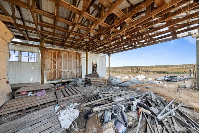 a view of roof with wooden floor and seating space