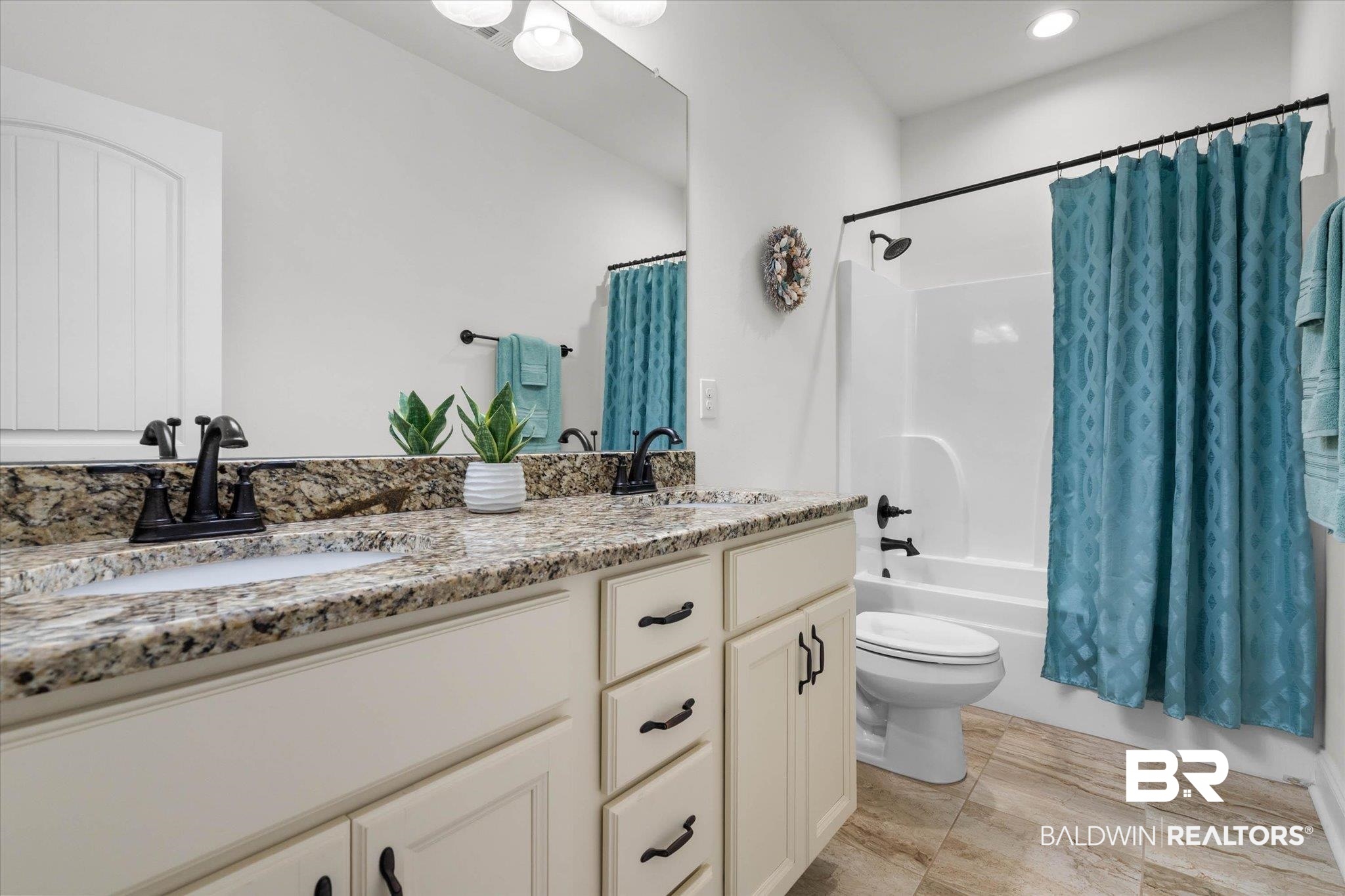1270 Surrey Loop Foley, AL 36535 - Photo 19 of 27 Double vanity with integrated sinks, speckled countertop, and matte black fixtures