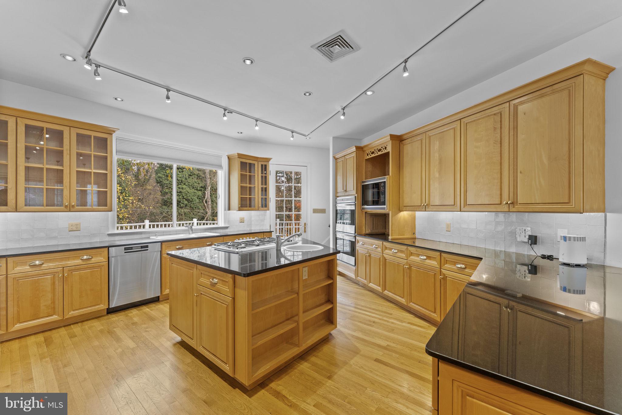 841 Mt Moro Road Villanova, PA 19085 - Photo 17 of 63 a kitchen with stainless steel appliances granite countertop a sink and cabinets