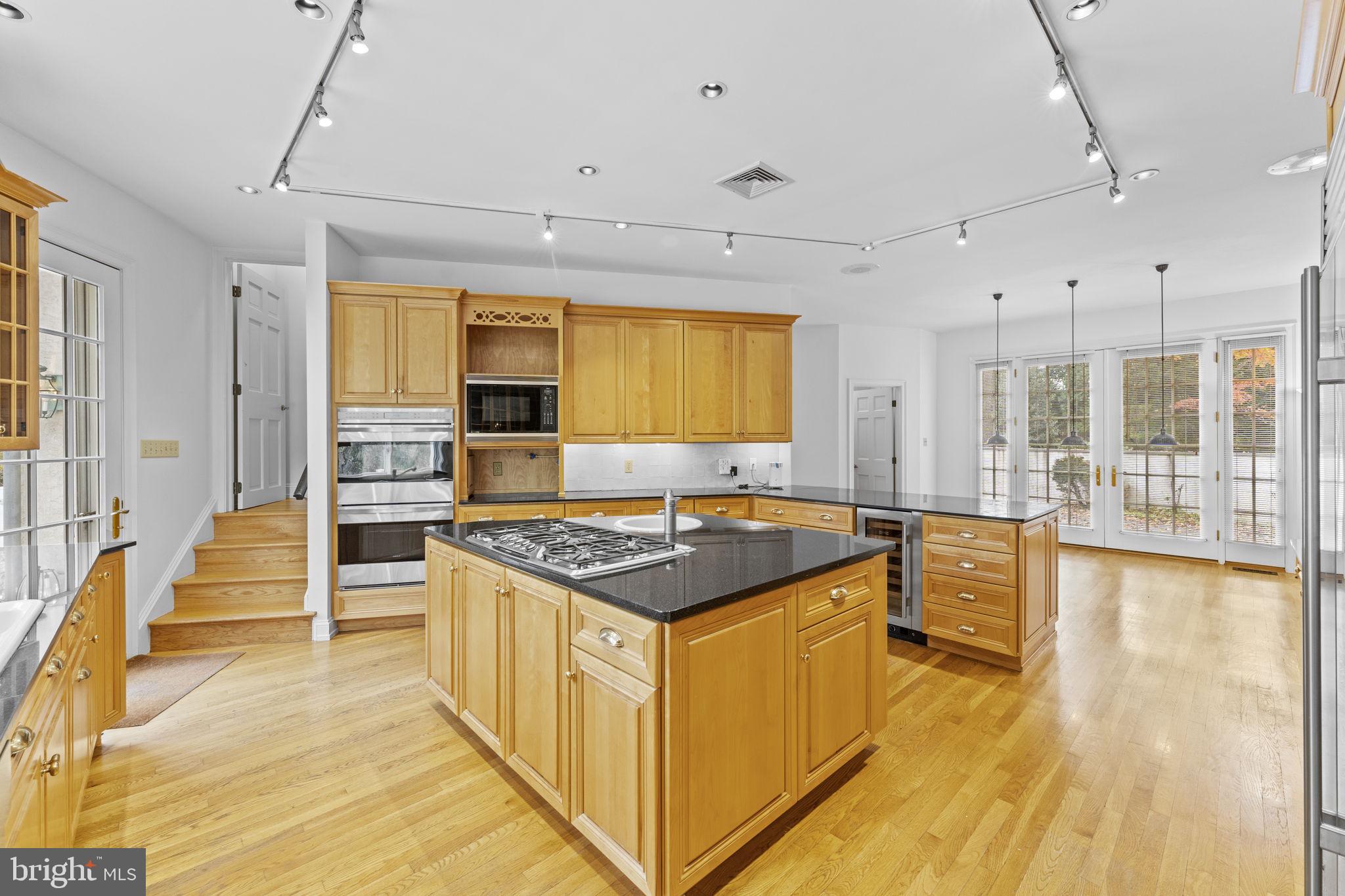 841 Mt Moro Road Villanova, PA 19085 - Photo 18 of 63 a kitchen with stainless steel appliances granite countertop a stove and a sink