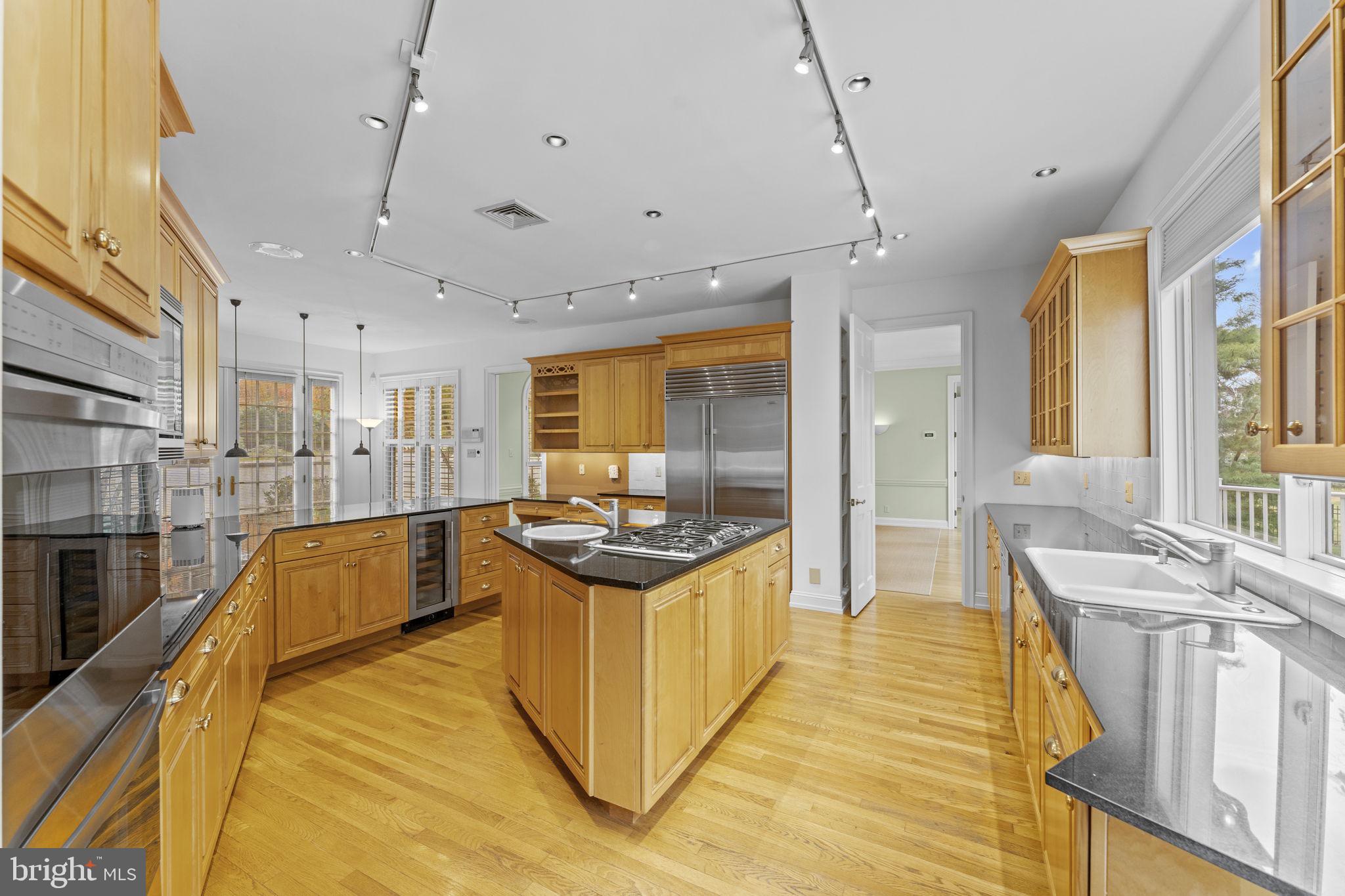 841 Mt Moro Road Villanova, PA 19085 - Photo 19 of 63 a kitchen with stainless steel appliances granite countertop a sink and wooden cabinets