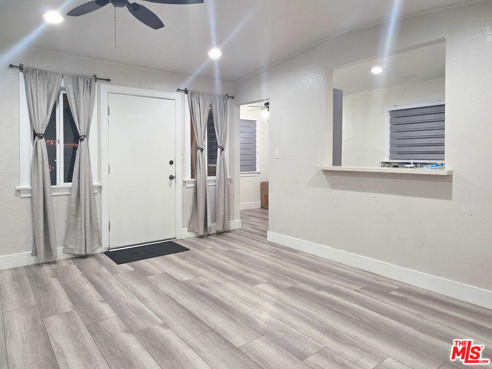 1111 North Spring Avenue Compton, CA 90221 - Photo 17 of 28 a view of a livingroom with wooden floor and a ceiling fan