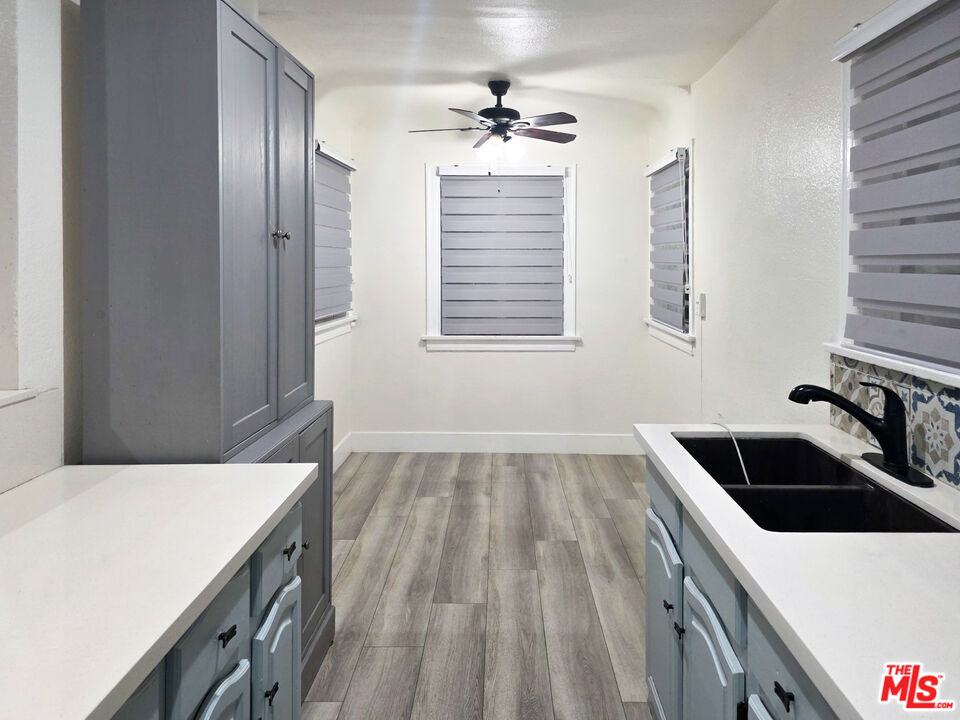 1111 North Spring Avenue Compton, CA 90221 - Photo 19 of 28 a kitchen with a sink a stove and cabinets