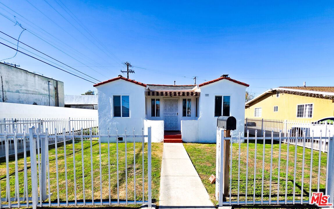 1111 North Spring Avenue Compton, CA 90221 - Photo 2 of 28 a front view of house with a garden