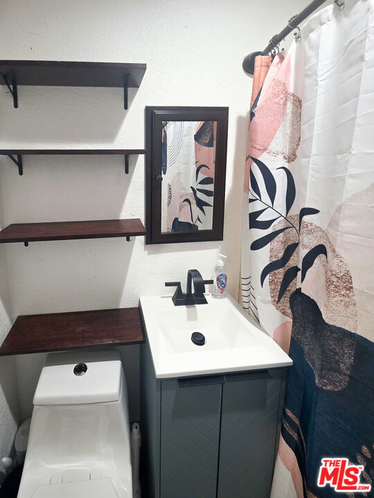 1111 North Spring Avenue Compton, CA 90221 - Photo 21 of 28 a bathroom with a sink and a mirror