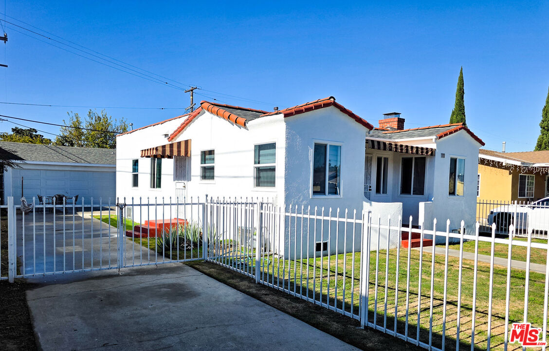 1111 North Spring Avenue Compton, CA 90221 - Photo 3 of 28 a view of a house with a small yard