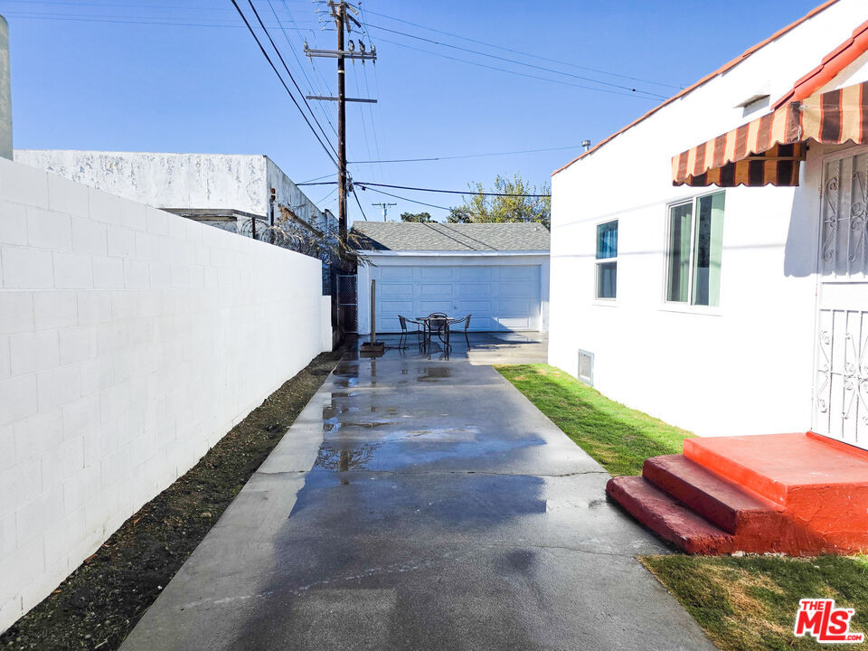 1111 North Spring Avenue Compton, CA 90221 - Photo 7 of 28 a view of a patio with a table and chairs