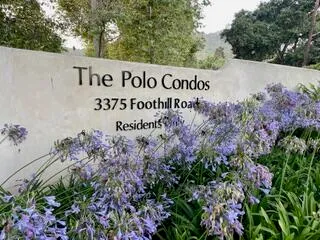a sign broad in front of flowers