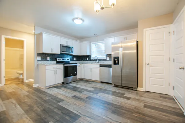 a kitchen with a refrigerator a sink and cabinets