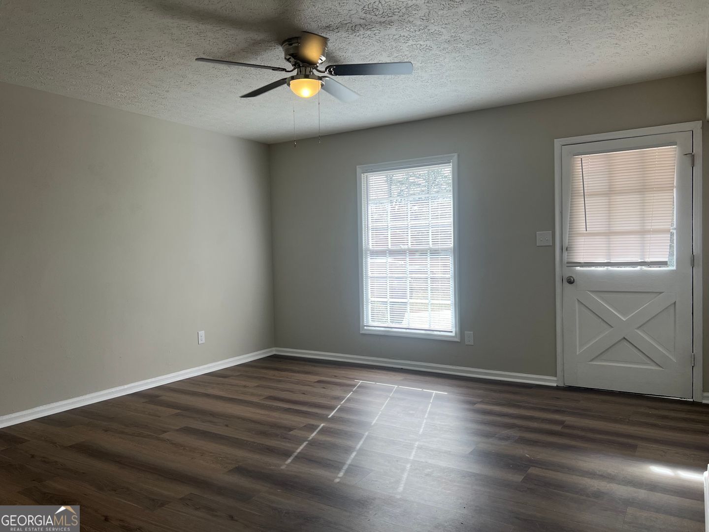 1695 East Broad Street, Unit A Athens, GA 30601 - Photo 4 of 13 an empty room with wooden floor and windows