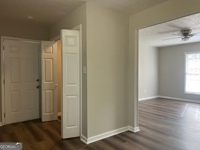 an empty room with wooden floor and a window