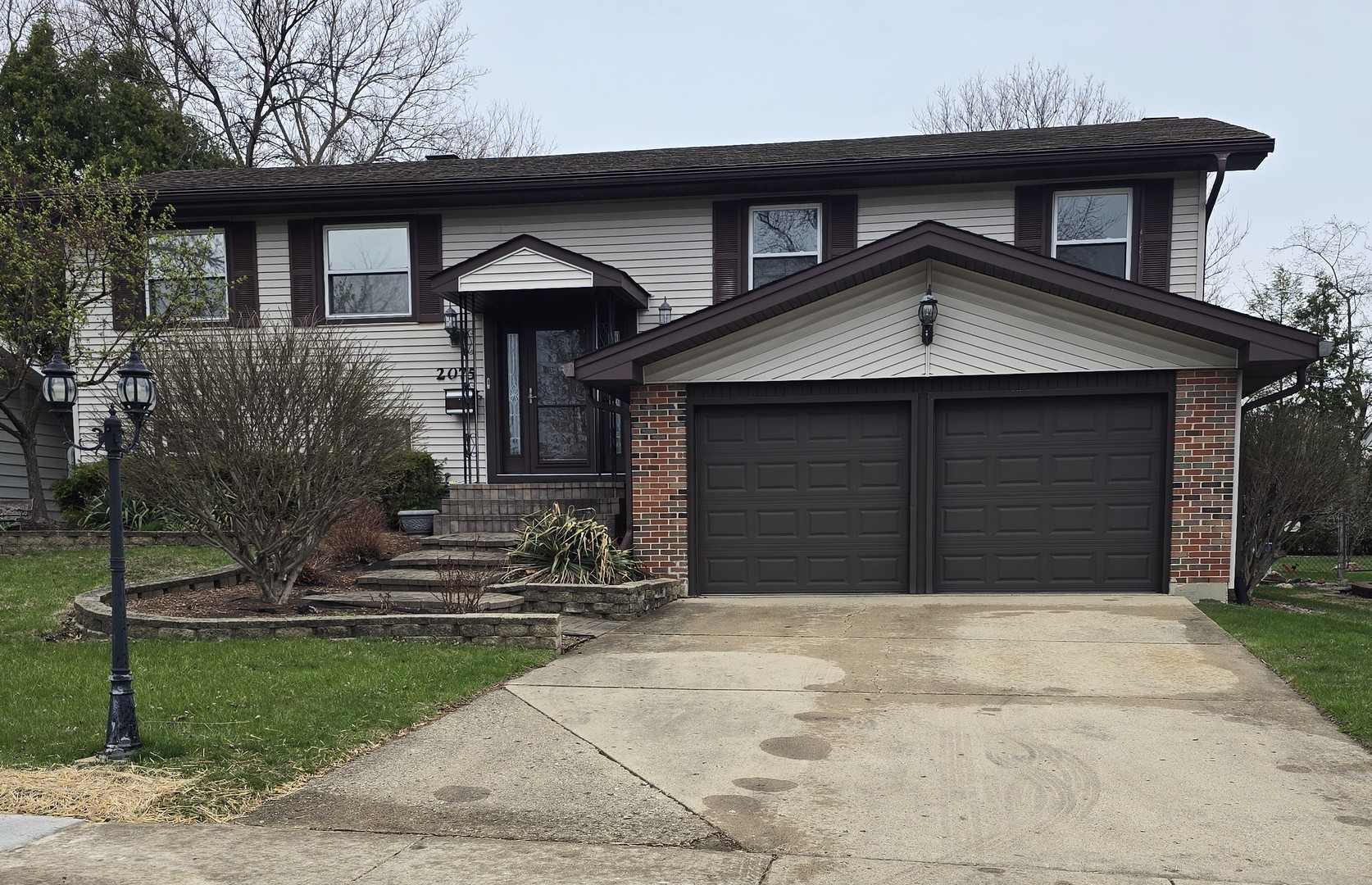a front view of a house with garage and yard