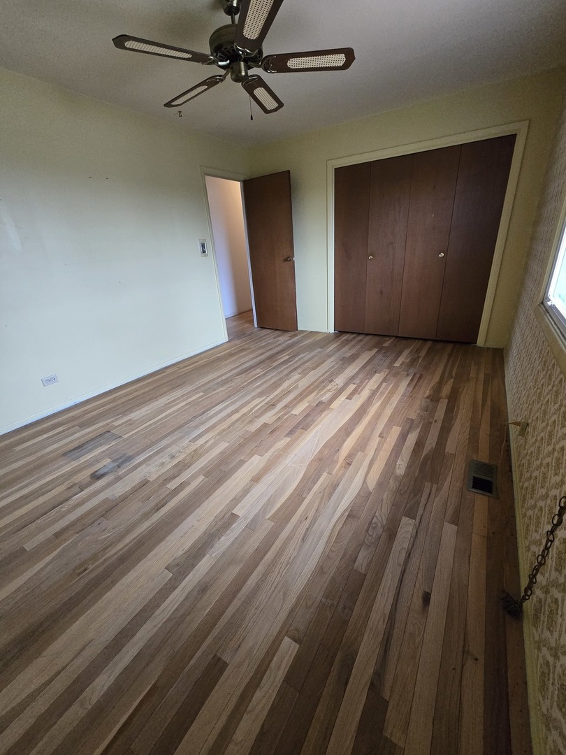 2075 Greenfield Road Hoffman Estates, IL 60169 - Photo 11 of 23 a view of an empty room with wooden floor and a window