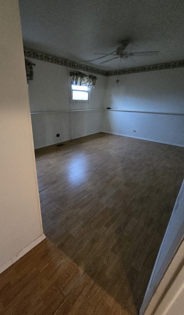 2075 Greenfield Road Hoffman Estates, IL 60169 - Photo 14 of 23 an empty room with wooden floor and windows