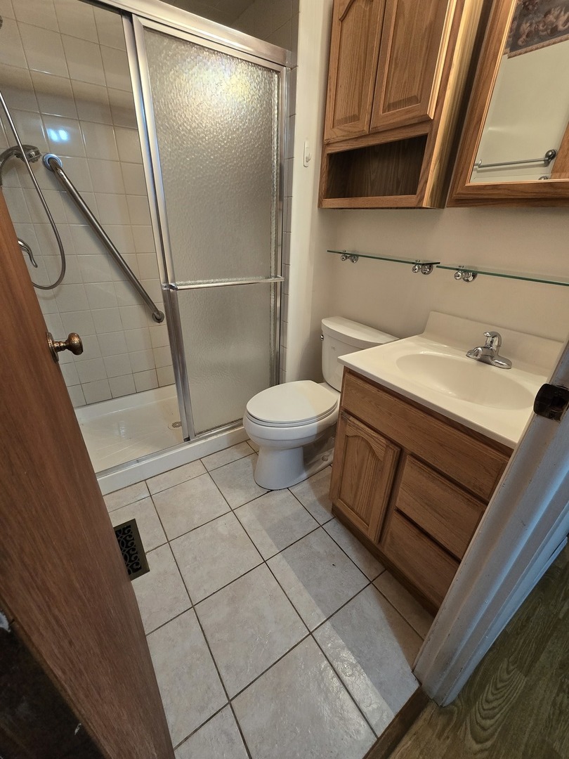 2075 Greenfield Road Hoffman Estates, IL 60169 - Photo 16 of 23 a bathroom with a sink and a toilet