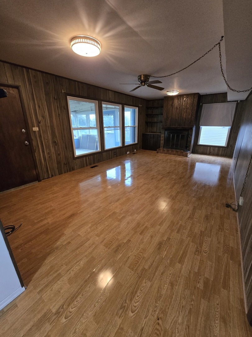 2075 Greenfield Road Hoffman Estates, IL 60169 - Photo 19 of 23 a view of an empty room with wooden floor and a window