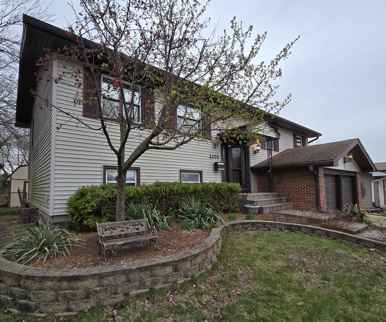 2075 Greenfield Road Hoffman Estates, IL 60169 - Photo 2 of 23 a front view of a house with garden