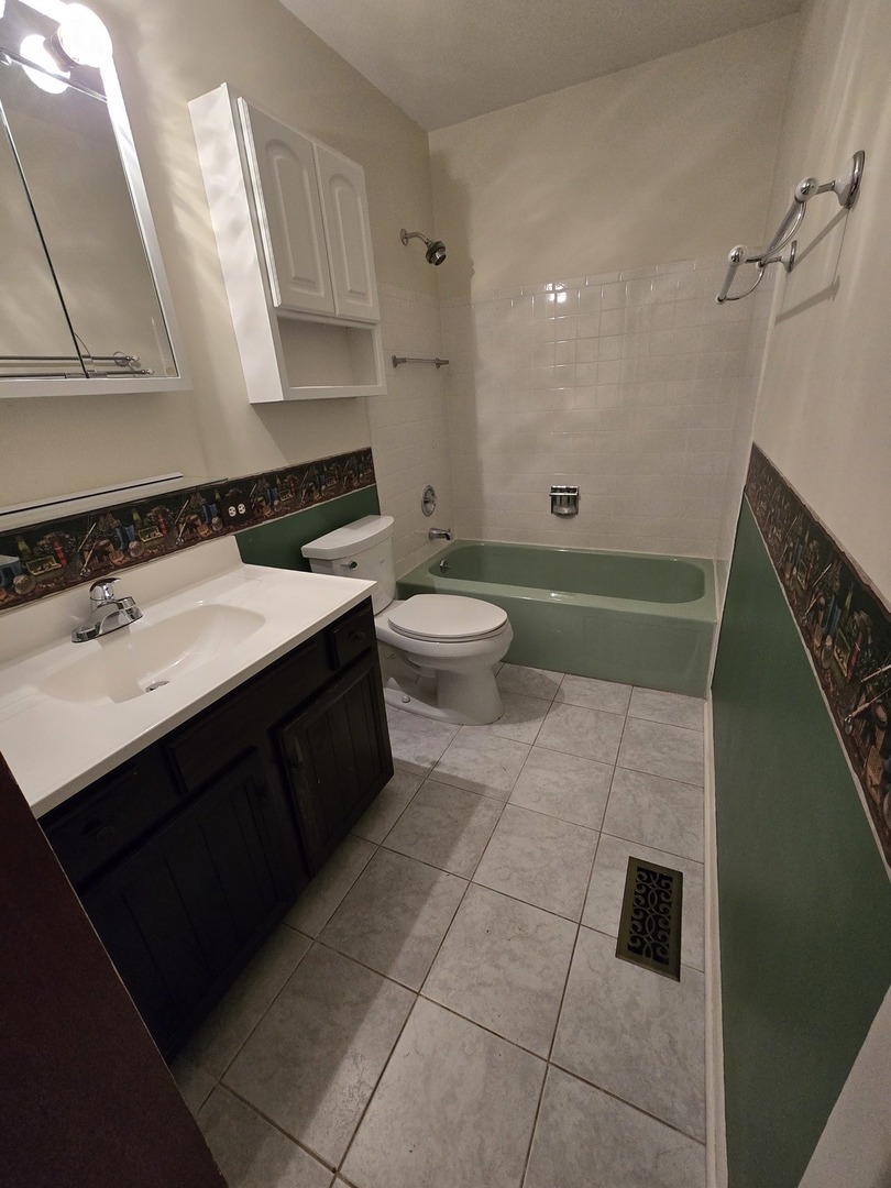 2075 Greenfield Road Hoffman Estates, IL 60169 - Photo 9 of 23 a bathroom with a sink a toilet and a mirror