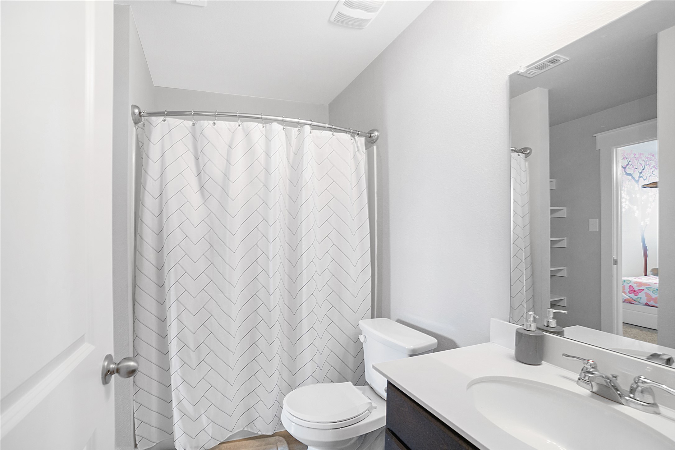 180 Waterside Road, Unit B Buda, TX 78610 - Photo 14 of 27 a bathroom with a sink a toilet and shower curtain