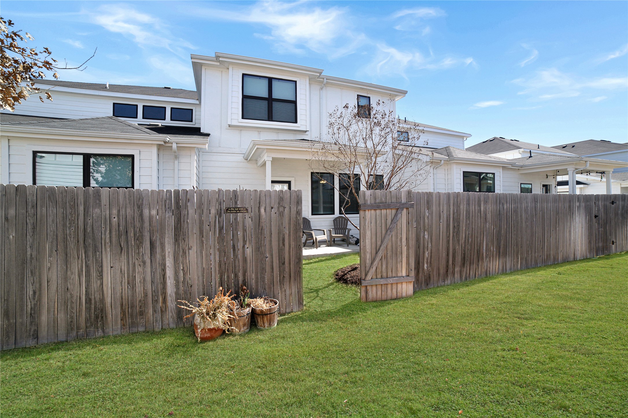 180 Waterside Road, Unit B Buda, TX 78610 - Photo 19 of 27 a front view of a house with garden