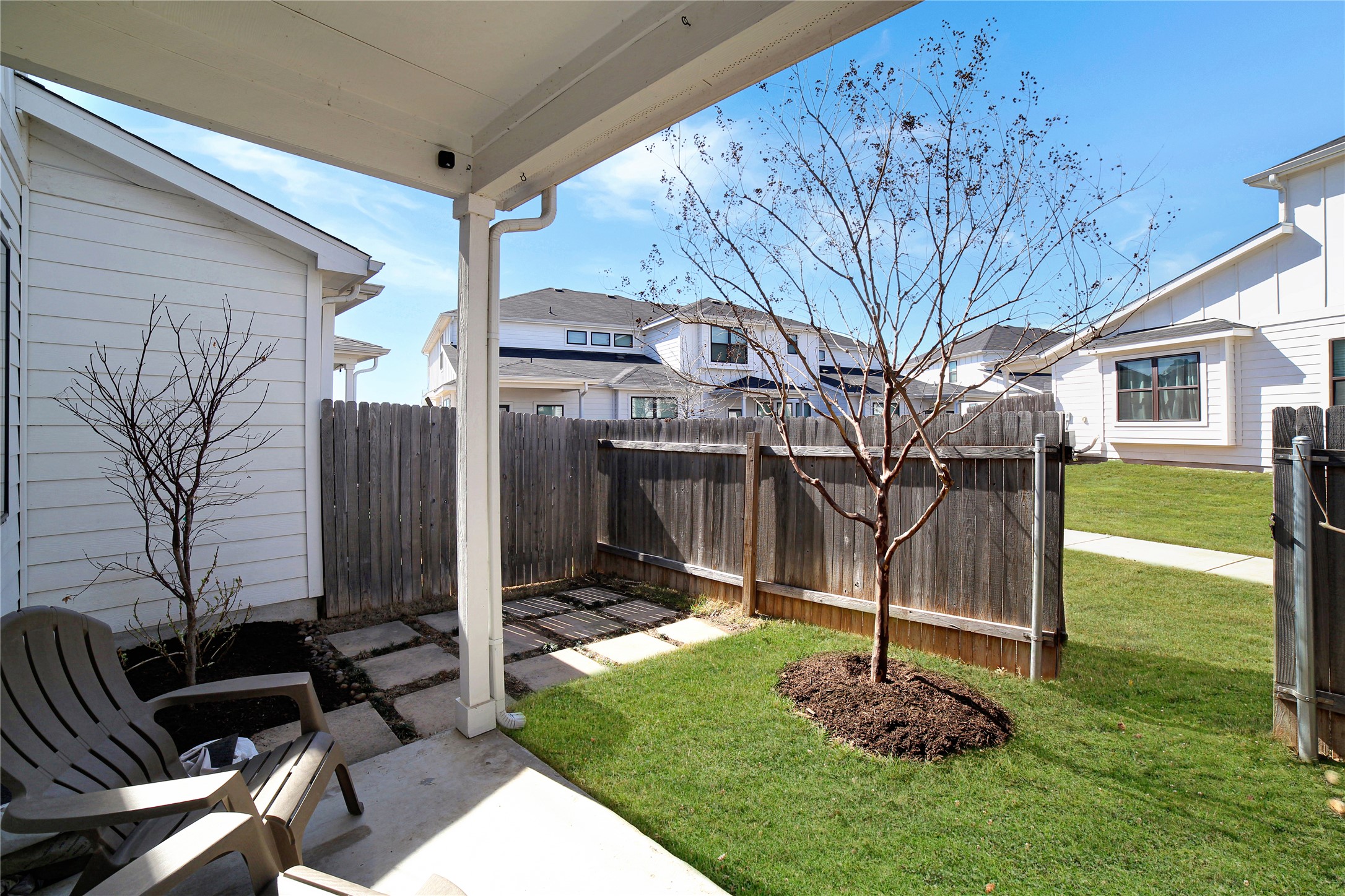 180 Waterside Road, Unit B Buda, TX 78610 - Photo 20 of 27 a backyard of a house with table and chairs