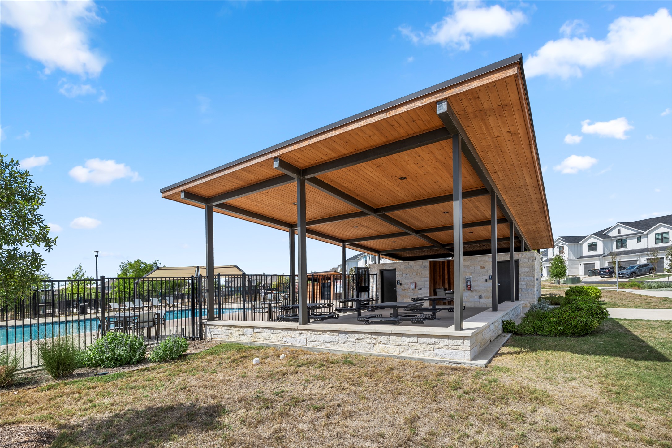 180 Waterside Road, Unit B Buda, TX 78610 - Photo 24 of 27 a view of a backyard with plants and a lake view