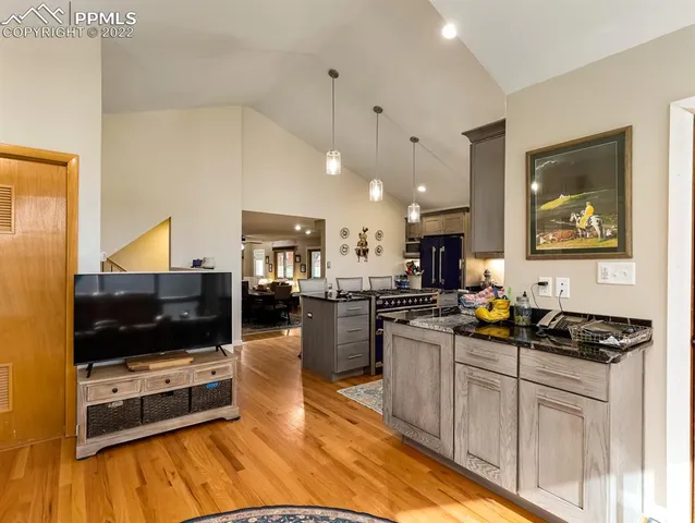 a kitchen with stainless steel appliances a stove a sink a microwave a refrigerator and cabinets