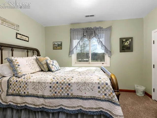 a living room with furniture and book shelf