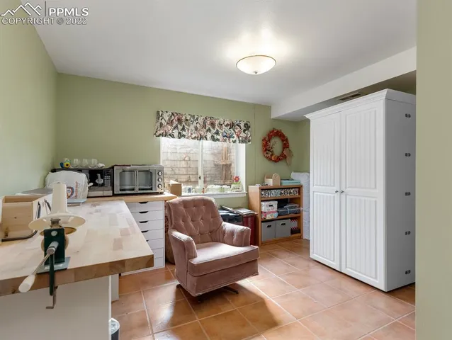 a view of a kitchen with fridge and workspace