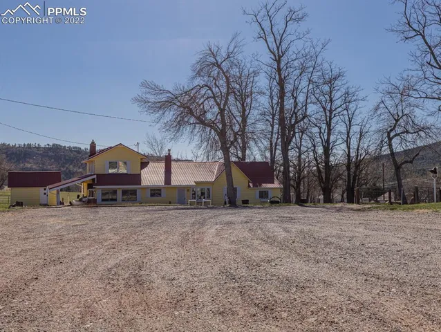 a view of a house with a snow in front of yard
