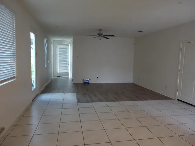 an empty room with white walls and tiles