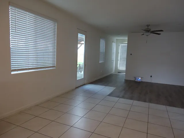 a large kitchen with stainless steel appliances a large counter top and a stove