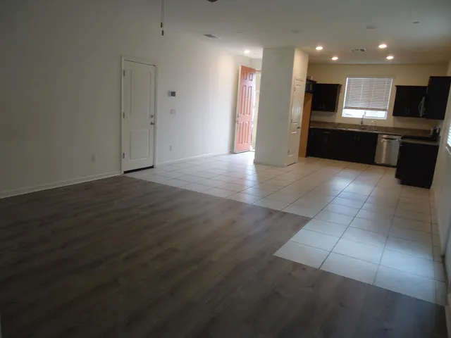 a kitchen with a sink a stove top oven and cabinets